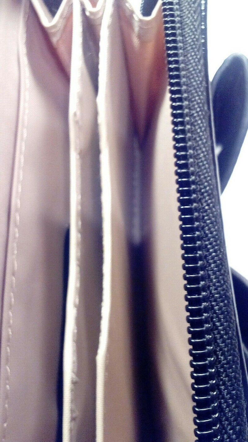 Nude zip around wallet with patent leather trim and bow.