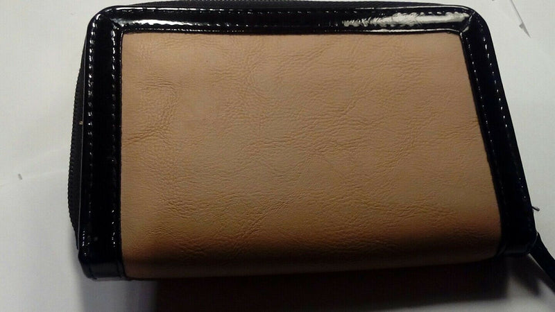 Nude zip around wallet with patent leather trim and bow.