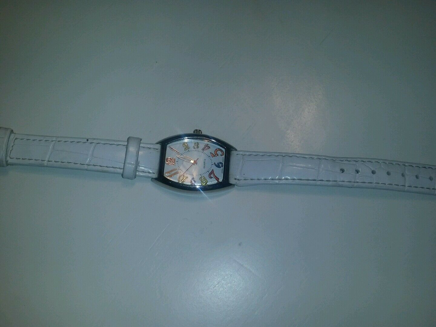 white quartz watch multi colored numerical batteries n/a